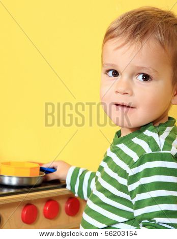 Cute european toddler having fun in kindergarten.
