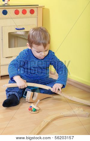 Cute european toddler playing in kindergarten.