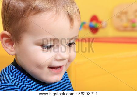 Cute caucasian toddler having fun in kindergarten.