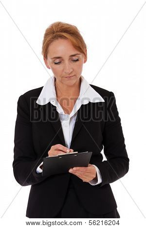 Attractive mature businesswoman writing on clipboard. All on white background.