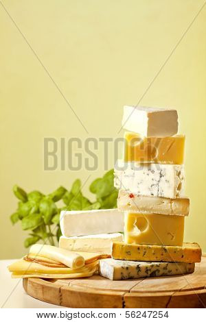 Pile of cheese many various types on cutting board