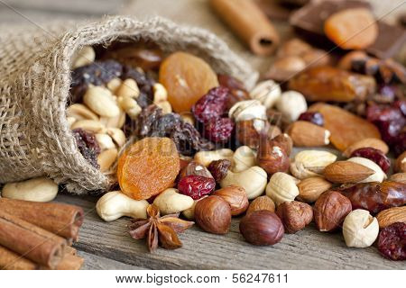 Nuts and dried fruits on vintage wooden boards