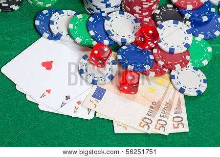 Dice, Four Aces, Colorful Poker Chips And Euro Banknotes On A Green Felt