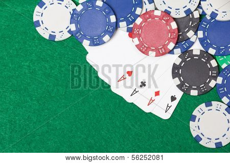 Poker Chips And Playing Cards On A Green Table Background