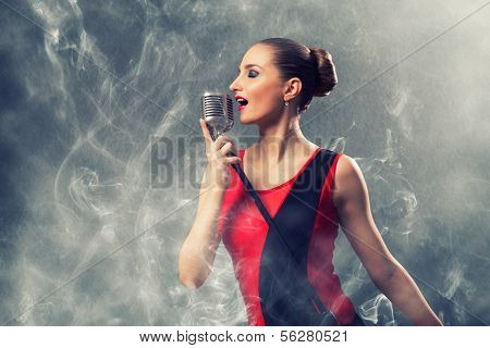 beautiful blonde woman singer with a microphone
