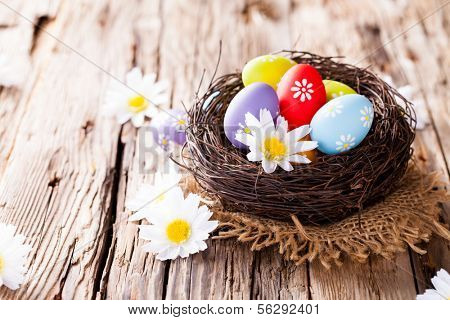 Easter still life with traditional decorative colored eggs in nest