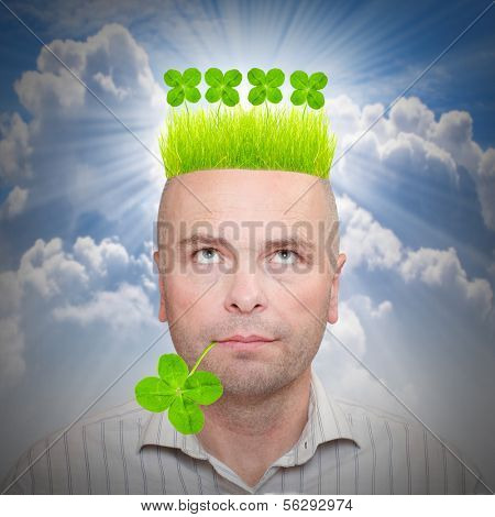 Happy irish man with four leaf clover and green hair. St. Patrick day concept.