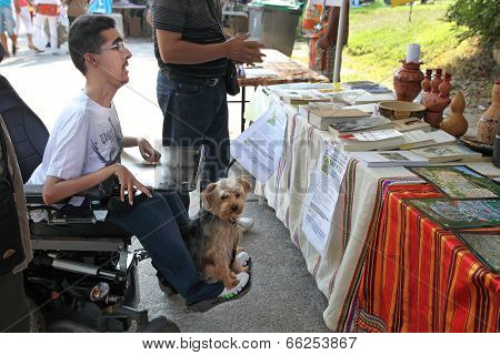 Marseille, France - August 26: Photo Of A Young Man In A Wheelchair With His Pet. Marseille Festival