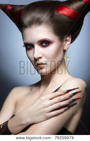 The girl in an image of the demon-tempter with long nails and haircut in the form of horns.