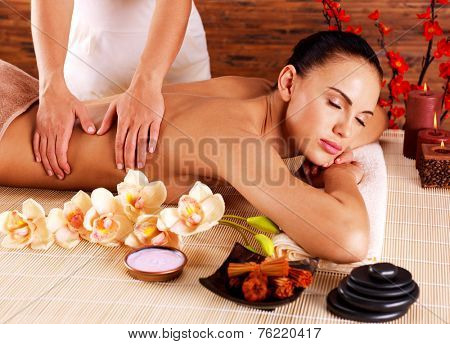Masseur doing massage on woman body in the spa salon. Beauty treatment concept.