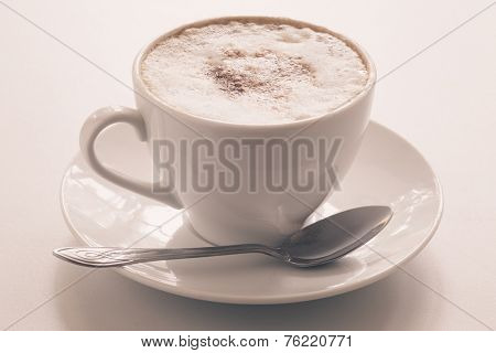 Cappuccino cup on a light background. Shallow depth of field