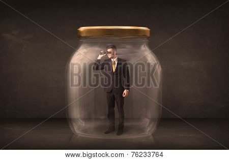 Businessman shut into a glass jar concept on background