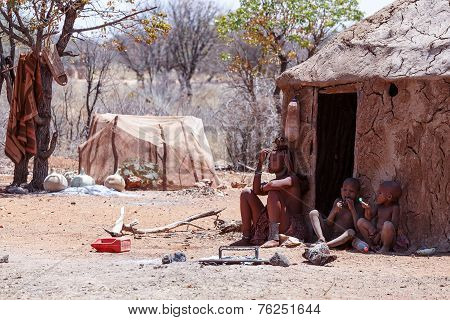 Himba Woman With Childs On The Neck In The Village