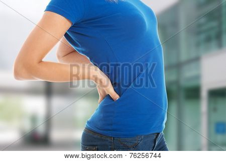 Young casual woman is having a backpain