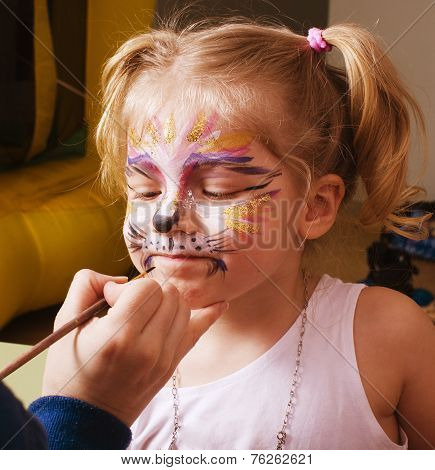 little girl with faceart on birthday party