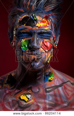 A creepy portrait of halloween moor with colour body art.