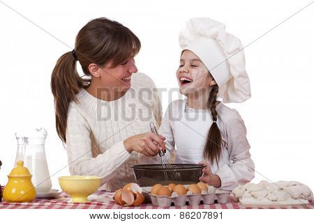 Happy mother with little daughter joyful cooking, isolated on white background
