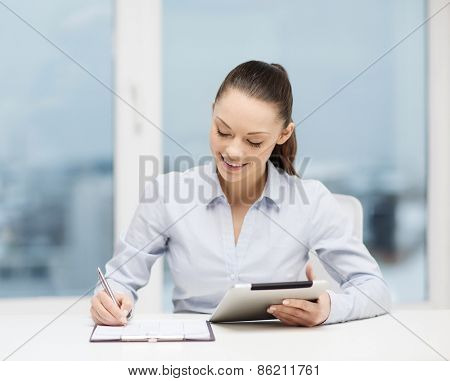 office, business, technology and internet concept - businesswoman with tablet pc and documents in office