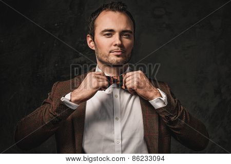 Cheerful sharp dressed fashionist wearing jacket and bow tie