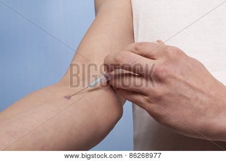 Drug addict man with syringe in action