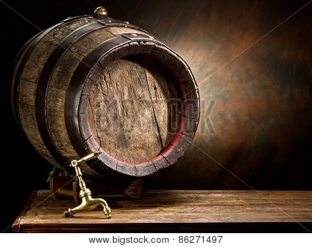 Old oak wine barrel on wooden table.