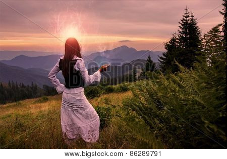 Mystic Woman In Ancient Dress Alone In A Romantic Sunset Landscape
