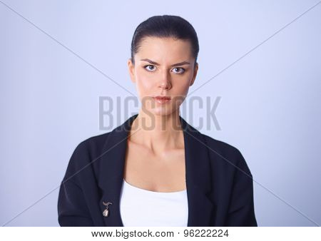 A young woman standing, isolated on graybackground