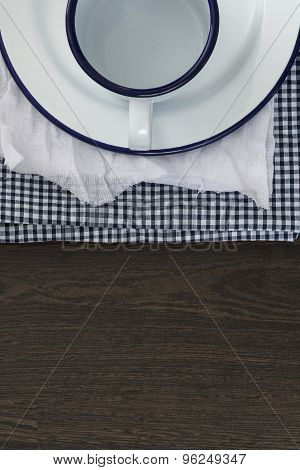 Vintage Enamelware Crockery On Retro Cloths On Rustic Wooden Background
