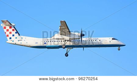 ZURICH - JULY 18: Croatian Bombardier Q400 landing in Zurich after short haul flight on July 18, 2015 in Zurich, Switzerland. Zurich airport is home for Swiss Air and one of the biggest European hubs.