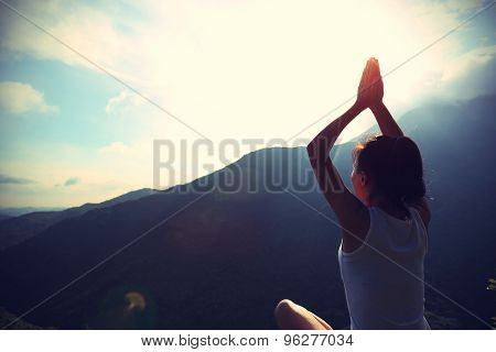 young yoga woman sit meditation on sunrise mountain peak