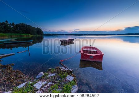 Beautiful Lake Sunset With Fisherman Boat