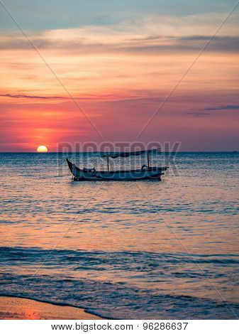 traditional Balinese ships Jukung close on Sanur beach at sunrise, Bali, Indonesia