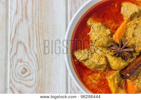 Top View Of Pork Mussaman Curry On Wood Background