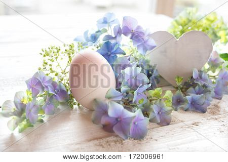 Tender easter motif with flowers and a heart for a greeting card