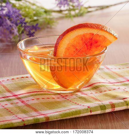 Orange jelly and orange slices in glass cup.
