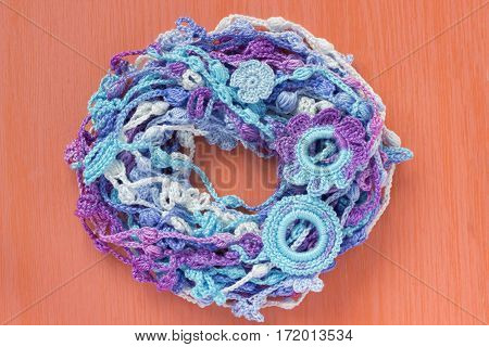Handmade crocheted cotton organic lace wreath. White crochet frame Knitted pattern handicraft background needlework creative craft. Bright crochet wreath with flowers place for text