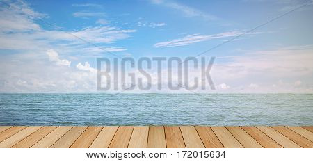 pier wood floor beside sea with blue sky background. summer relaxing time.
