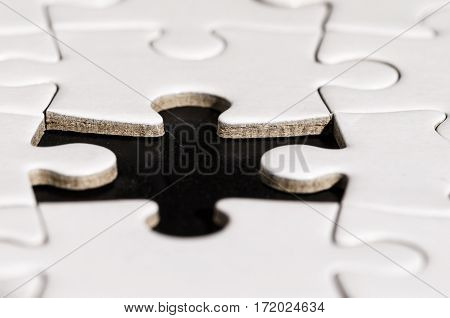 close up of a jigsaw with a piace lacking. problem solving. business.