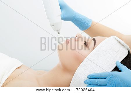 Brushing, brush-peeling, brossage. Nozzle polishing stone. Model with closed eyes, profile, close-up. Cosmetological clinic procedures Healthcare clinic cosmetology