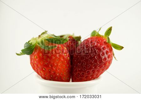 3 strawberries have white background.Red color stand and cut white background.