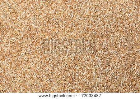 Texture Of Raw Wheat Grits Background.