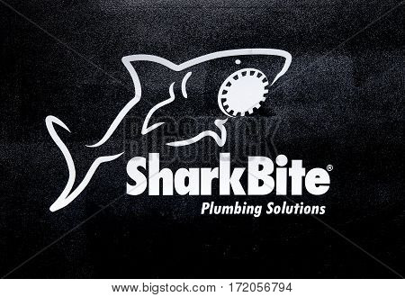 Moscow, Russia - February, 2016: SharkBite company logo. Printed sticker letters. SharkBite manufactures a wide range of plumbing fittings, water control valves and PEX pipe