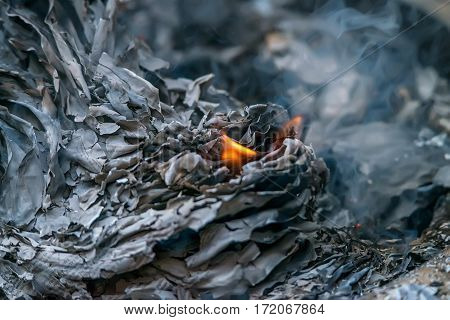 Burnig paper pages and remaining ashes and ember