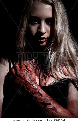 Pale bloody blond woman over black background
