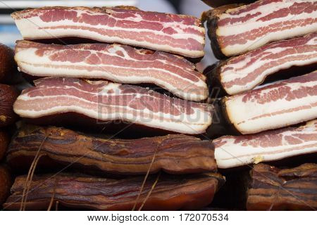 Home made smoked bacon in a street market