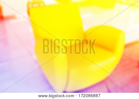 Abstract blurred modern yellow chair in office