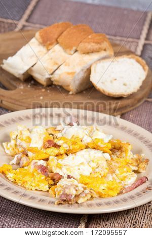 Fried eggs with bacon served on the table.