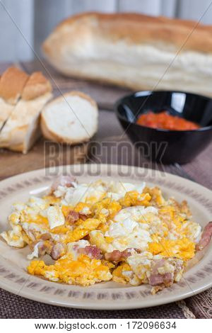 Breakfast table with fried eggs and bacon.