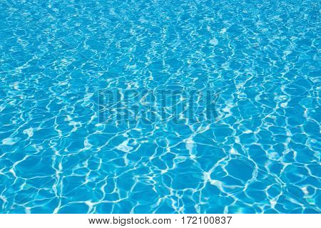 Blue pool water background wave. Clean and bright water in swimming pool.