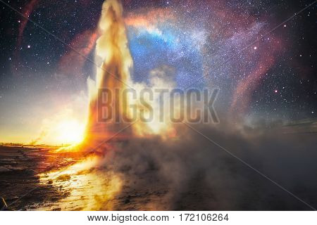Strokkur geyser eruption in Iceland. Fantastic colors. The magical starry sky. Courtesy of NASA